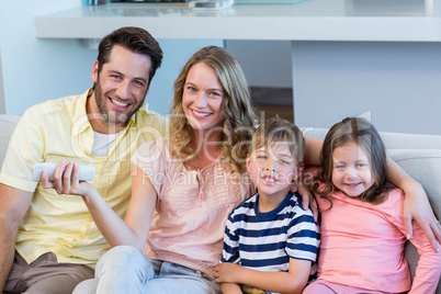 Happy family on the couch watching tv