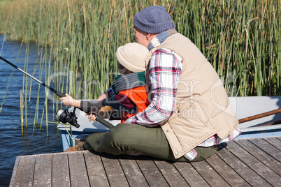 Happy man fishing with his son