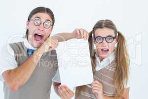 Geeky hipsters holding a poster