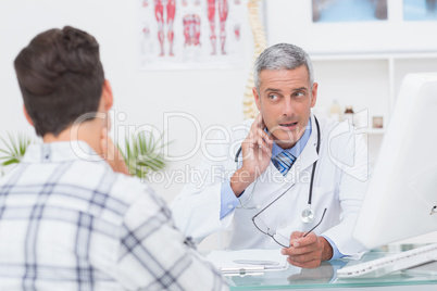Doctor examining patient with neck ache