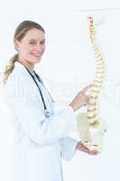 Female doctor with anatomical spine