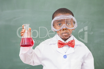 Sad pupil holding at a red liquid