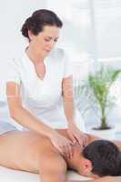 Physiotherapist doing neck massage to her patient