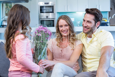 Daughter surprising mother with flowers