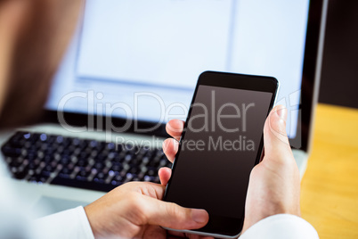 Man using laptop and smartphone