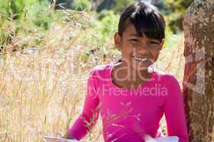 Cute little girl reading in park