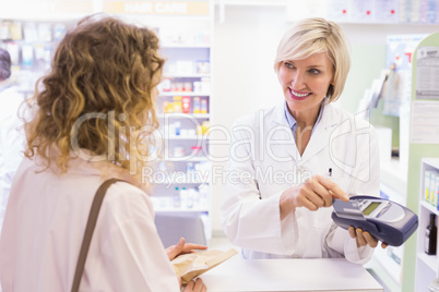 Pharmacist using card machine