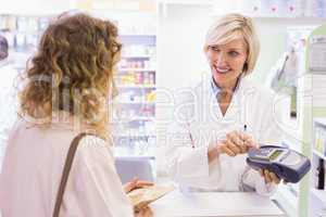 Pharmacist using card machine