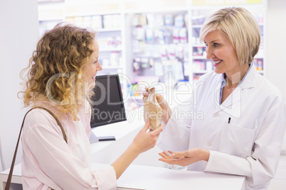 Pharmacist giving medicine to costumer