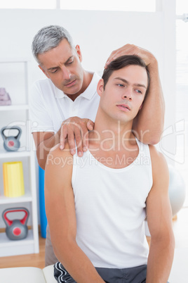 Doctor doing neck adjustment