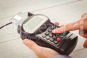 Man entering his pin on terminal