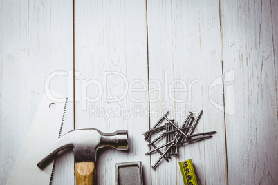 Hammer and nails laid out on table