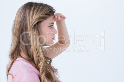 Pretty blonde looking the horizon with hand on forehead