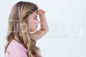 Pretty blonde looking the horizon with hand on forehead