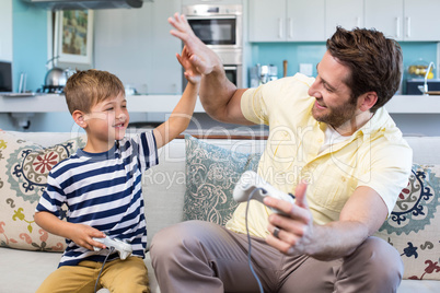 Father and son playing video games together