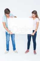 Hipster couple holding poster