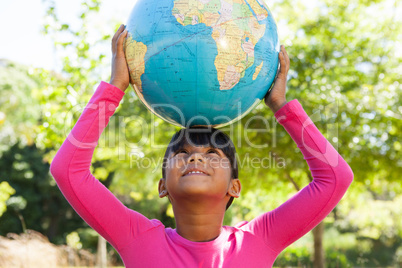 Cute little girl holding globe