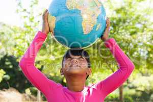 Cute little girl holding globe