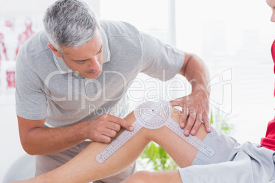 Doctor examining man leg