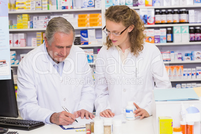 Team of pharmacist looking a medication for a prescription