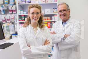 Smiling pharmacists with arms crossed