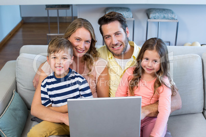 Happy family using the laptop together