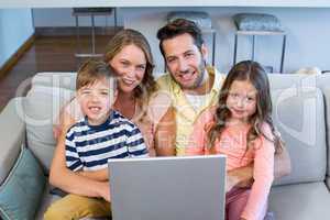 Happy family using the laptop together