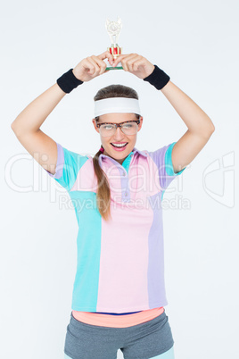 Geeky hipster holding winners trophy