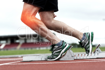 Highlighted knee of man about to race