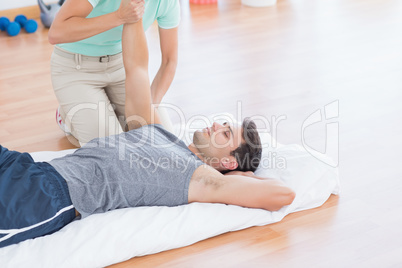 Man stretching with his trainer