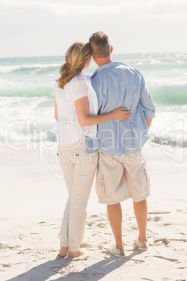 Happy couple looking out to sea