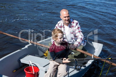 Happy man fishing with his son