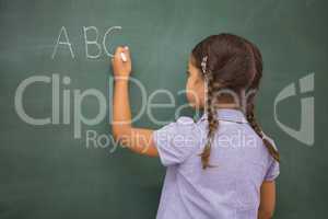 Pupil writing letters on a blackboard