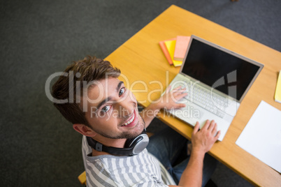 Student studying in the library with laptop