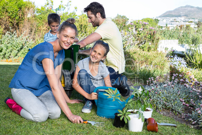 Happy young family gardening together