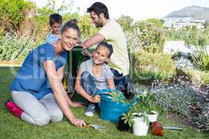 Happy young family gardening together