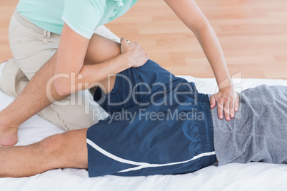 Man stretching with his trainer