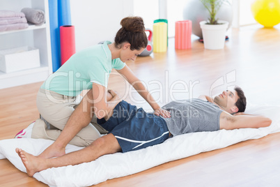 Man stretching with his trainer