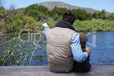 Happy casual father and son at a lake