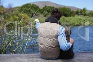 Happy casual father and son at a lake