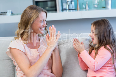 Happy mother and daughter on the couch