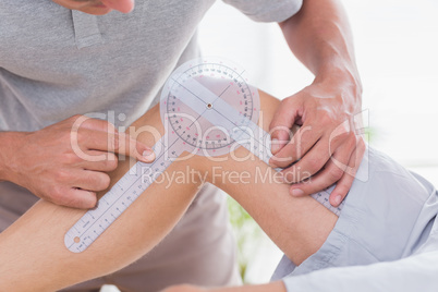 Doctor examining man leg