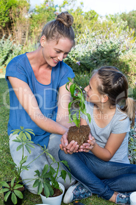 Mother and daughter tending to flowers