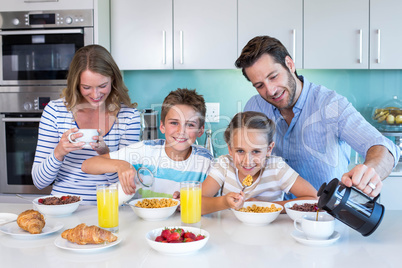 Happy family having breakfast together