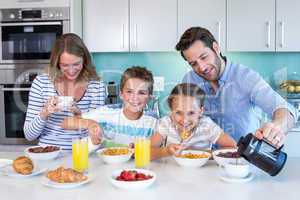 Happy family having breakfast together