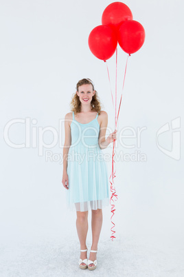 Happy hipster woman holding balloons