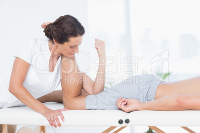 Physiotherapist doing leg massage to her patient