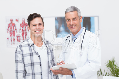 Doctor showing clipboard to his patient