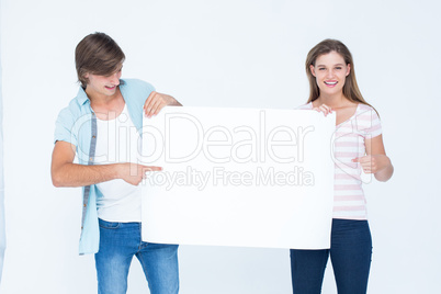 Hipster couple holding poster