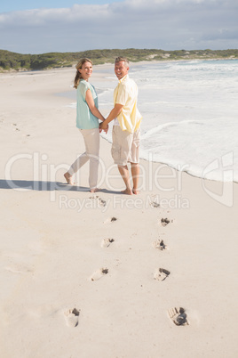 Happy couple walking holding hands